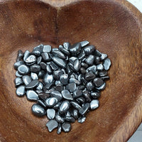 video of tumbled mini hematite chips being poured into a bowl