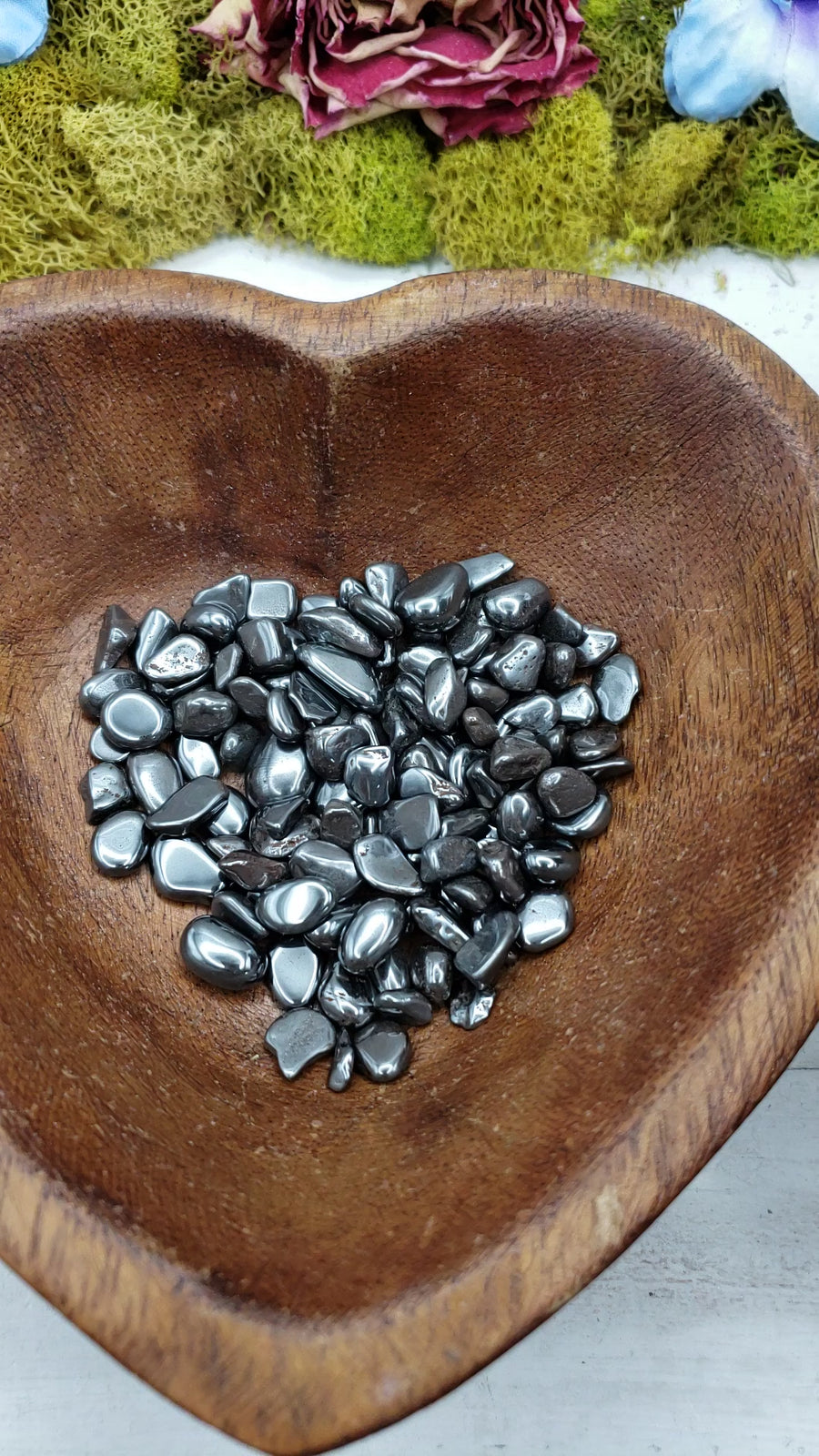 video of tumbled mini hematite chips being poured into a bowl