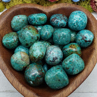 chrysocolla stones in heart-shaped bowl