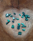 malachite crystal chips being poured into bowl