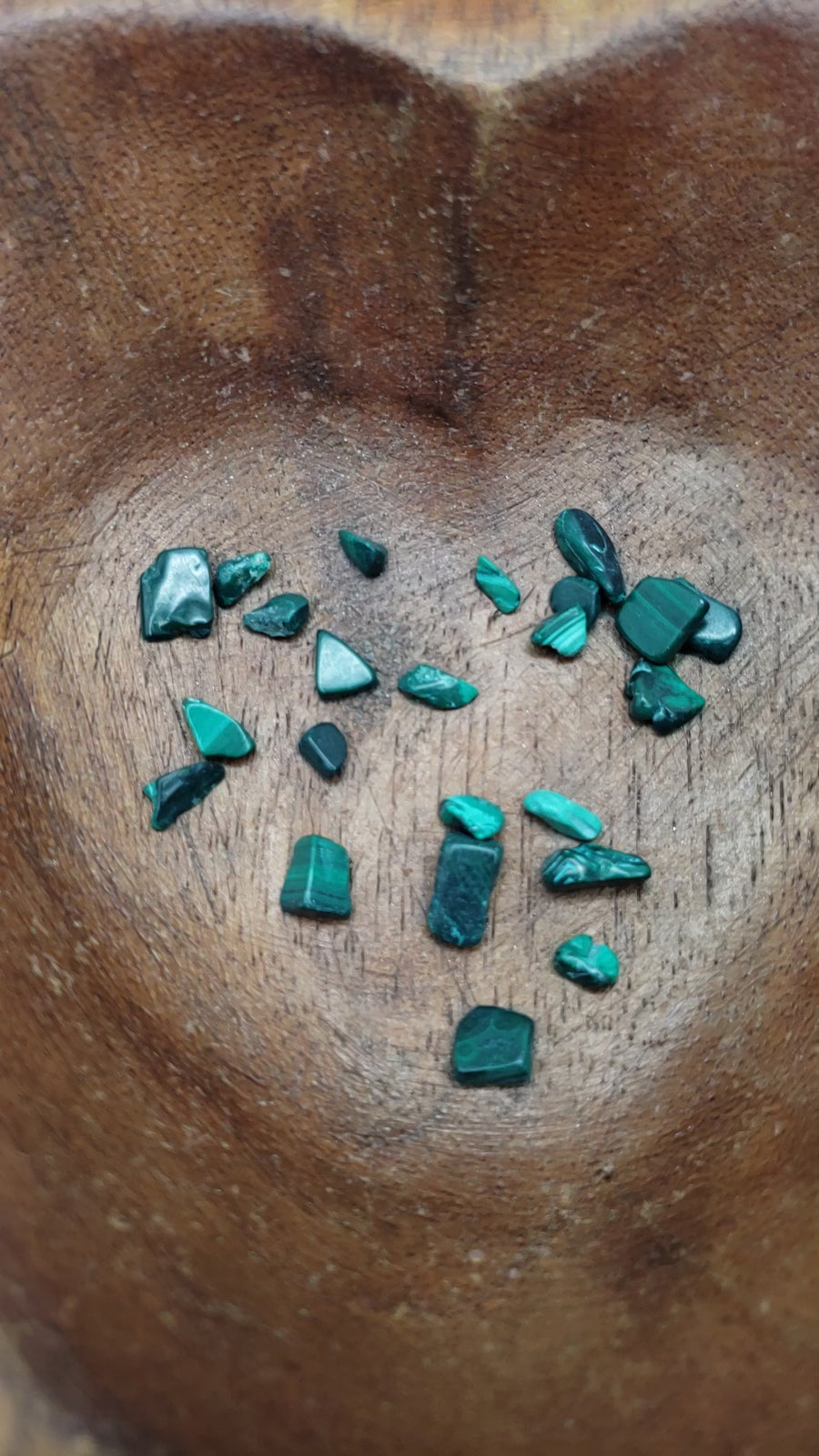 malachite crystal chips being poured into bowl