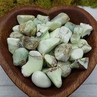 video of yellow chrysoprase stones in heart-shaped bowl