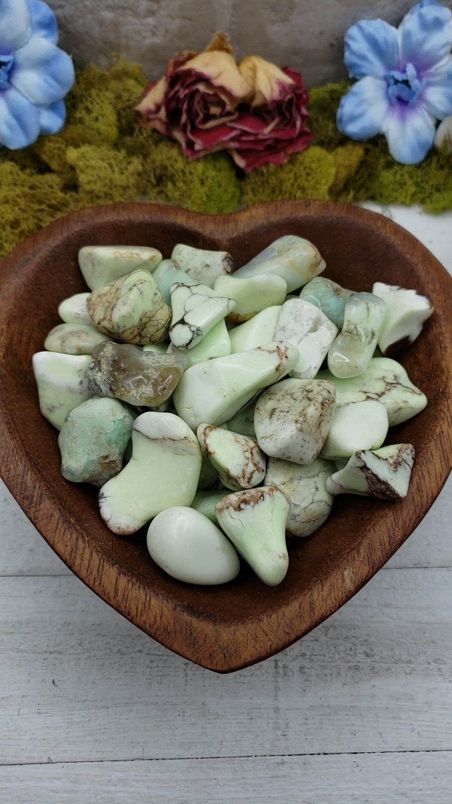 video of yellow chrysoprase stones in heart-shaped bowl