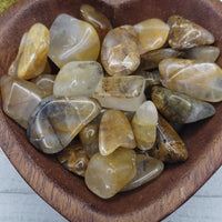Hematoid Gold Quartz Stones in heart-shaped bowl