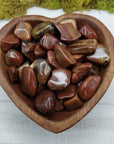 red agatized wood stone in heart-shaped bowl