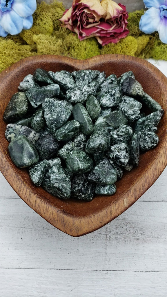 tumbled seraphinite stones in heart-shaped bowl
