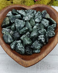 tumbled seraphinite stones in heart-shaped bowl