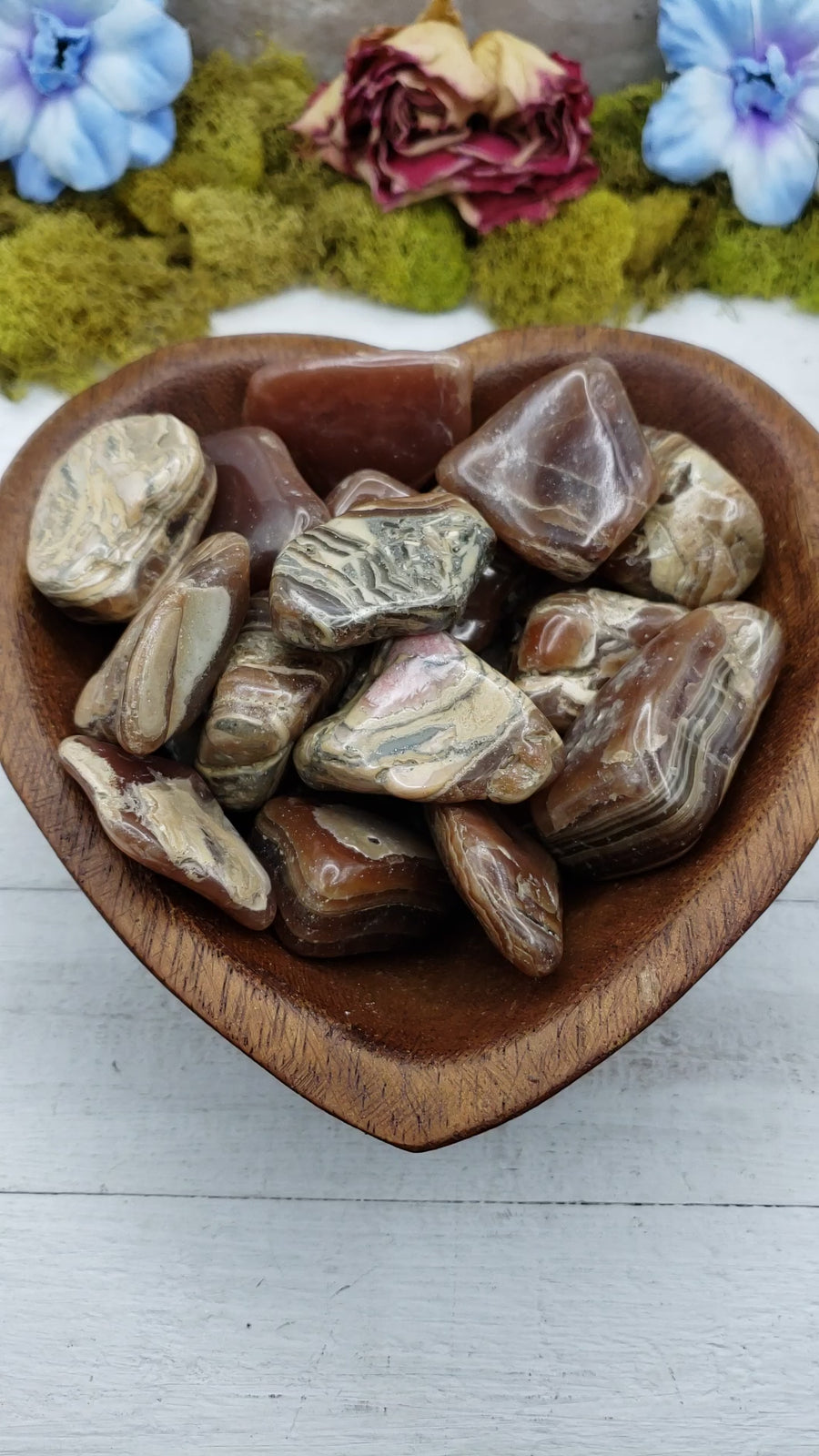 chocolate rhodocrosite stones in heart-shaped bowl