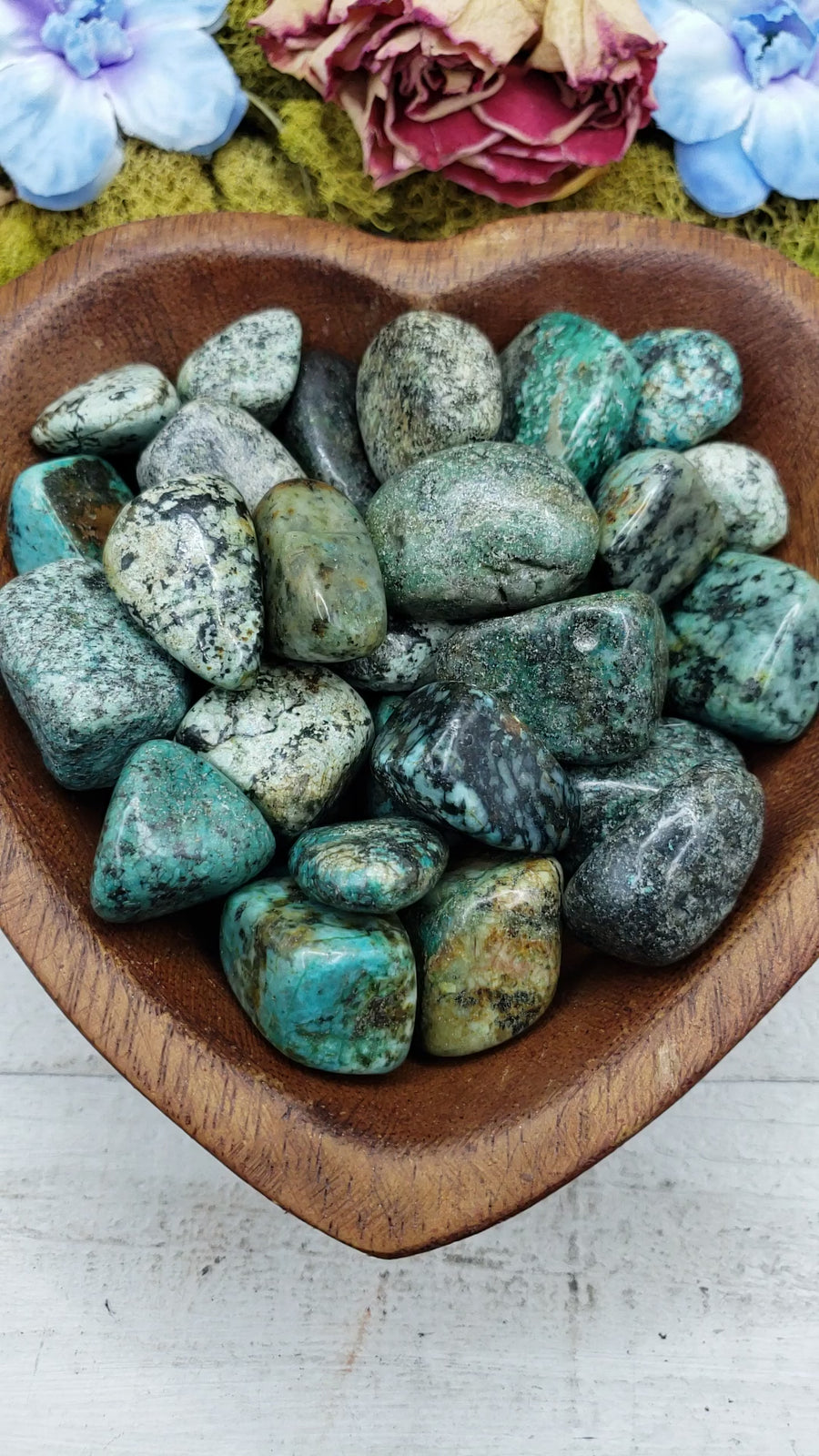 african turquoise stones being poured into bowl