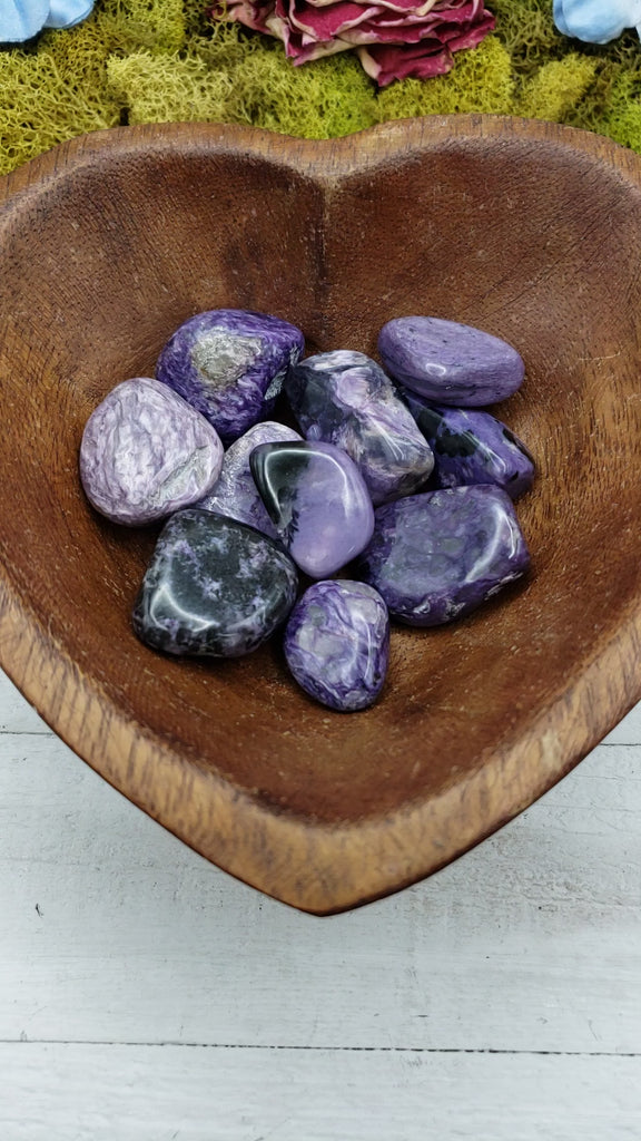 video of charoite stone pieces in wooden bowl