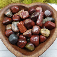 rainbow jasper stones in heart-shaped bowl