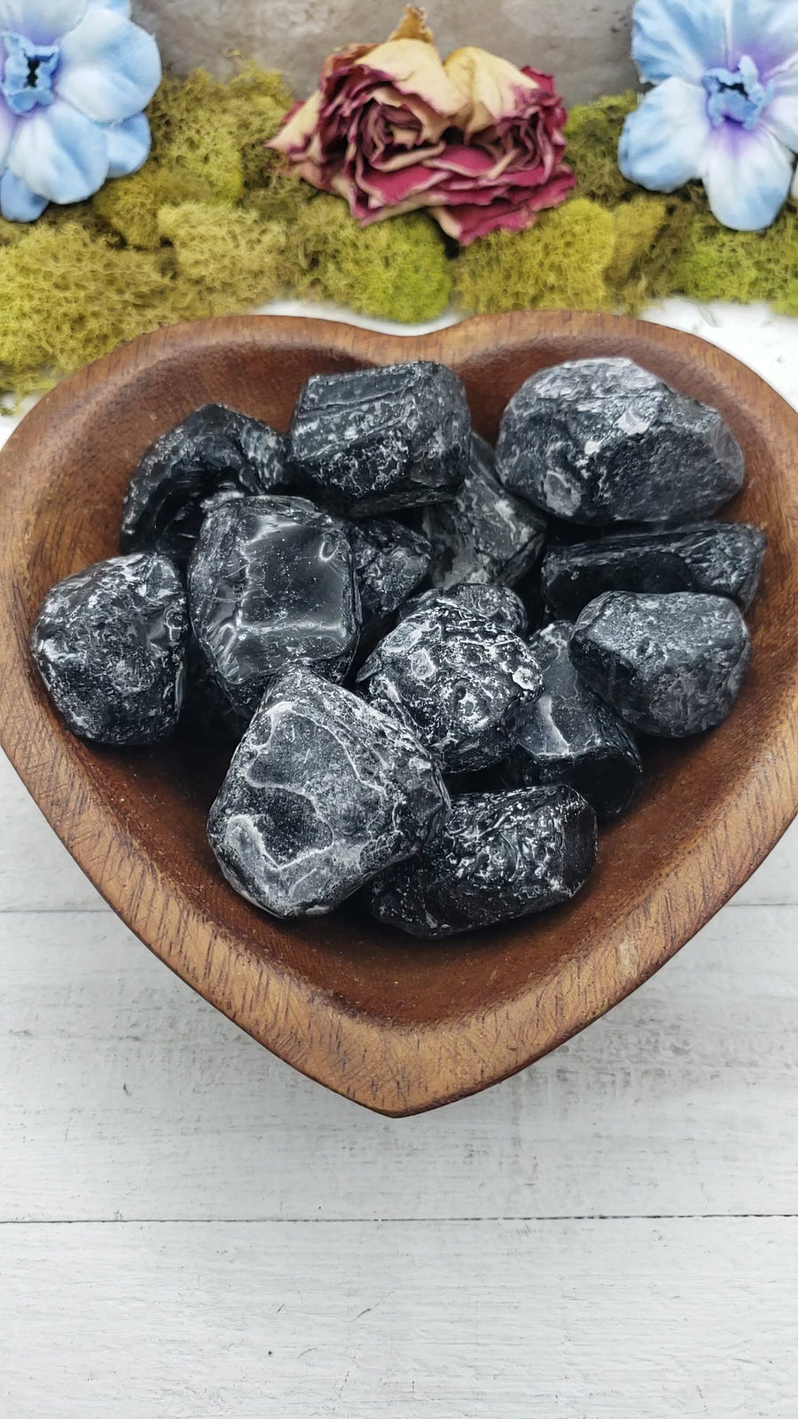 apache tear stones in heart-shaped bowl