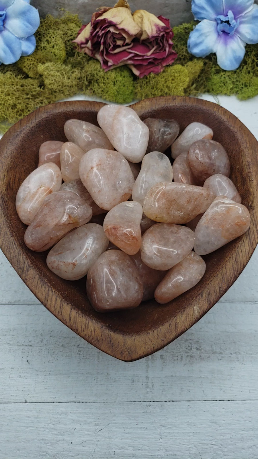 video of light strawberry quartz stones in heart-shaped bowl