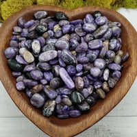 charoite stones in heart-shaped bowl
