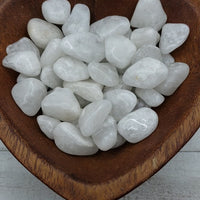 milky quartz stones in heart-shaped bowl