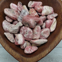 rhodocrosite stones in heart-shaped bowl
