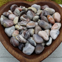 pink botswana agate stones in heart-shaped bowl