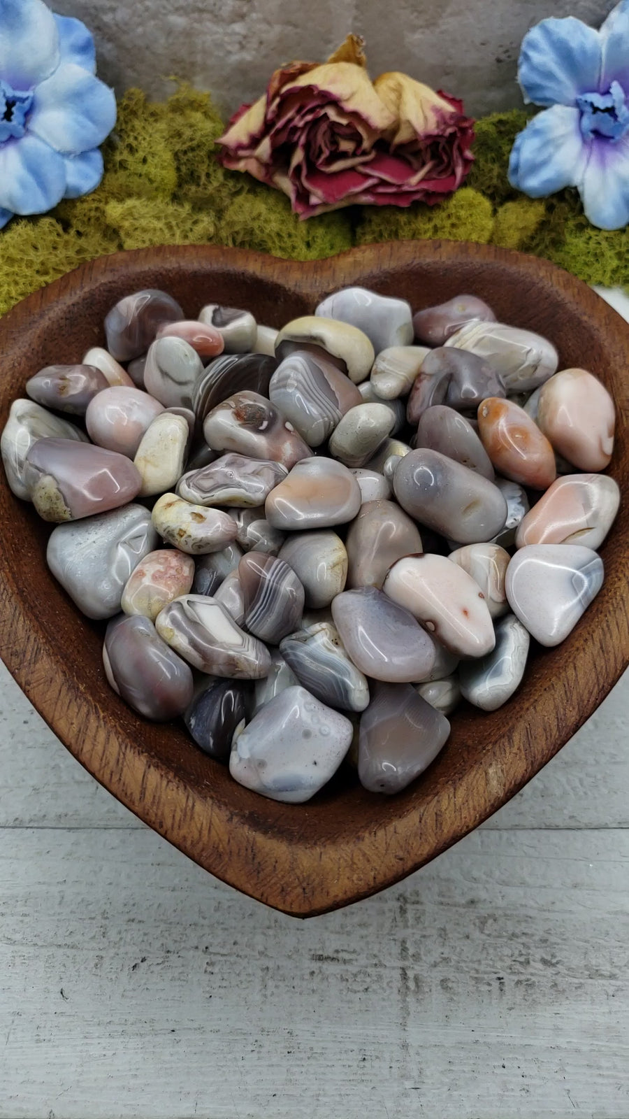 pink botswana agate stones in heart-shaped bowl