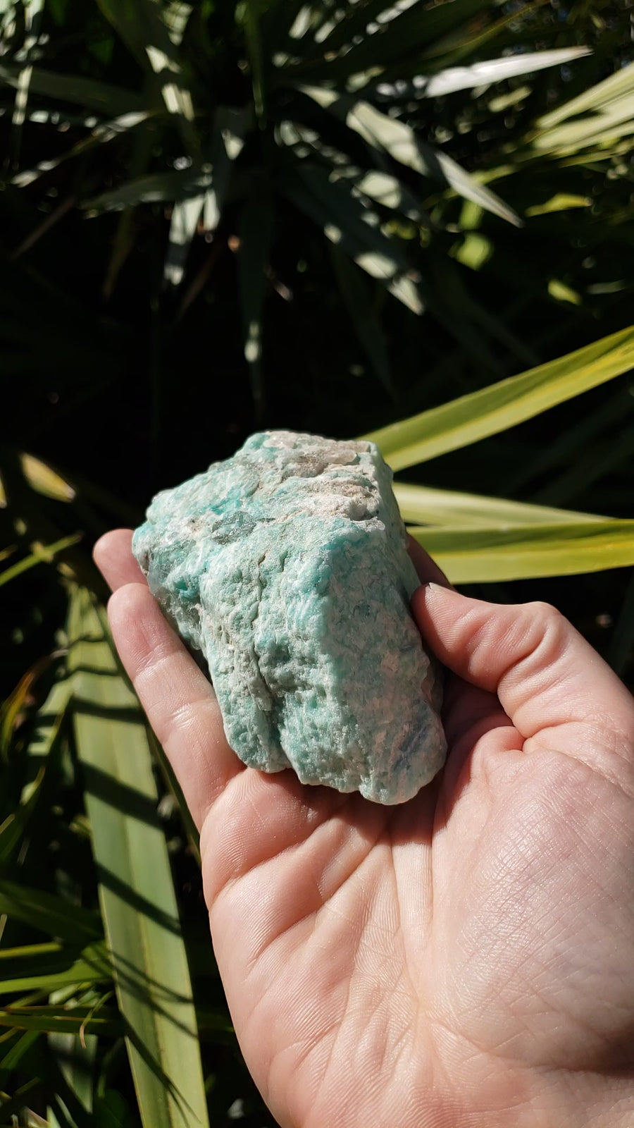 Video of rough amazonite in hand, showing of various sides