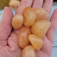 video of tumbled yellow aventurine stones in hand