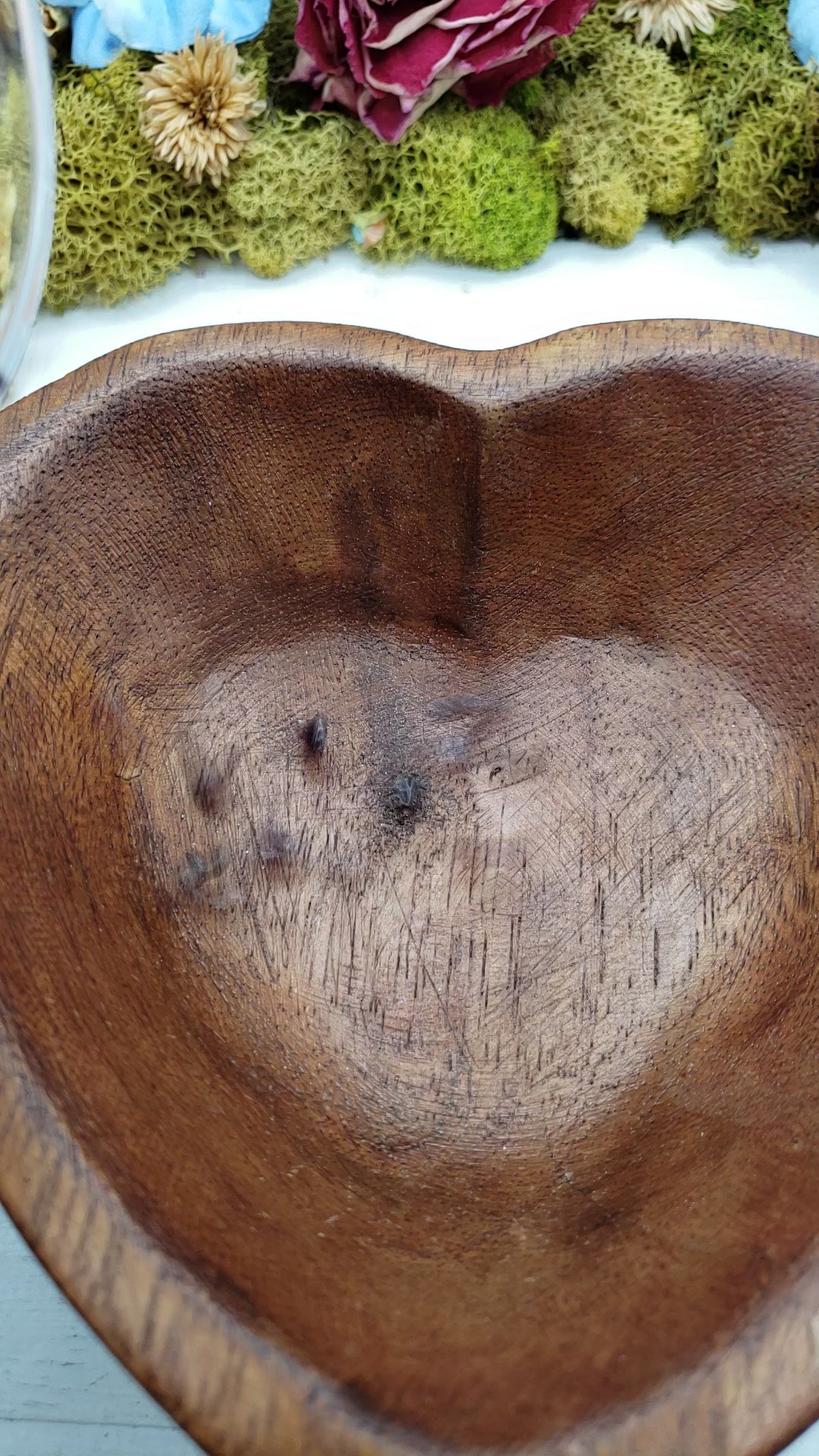 Video of garnet stone chips being poured into wooden bowl