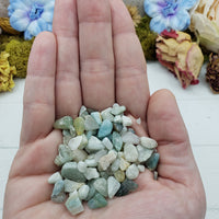 hand holding one ounce of amazonite stone chips