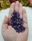hand holding one ounce of amethyst crystal chips