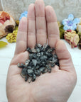hand holding one ounce of black tourmaline rutilated quartz chips