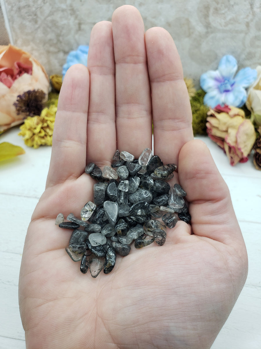 hand holding one ounce of black tourmaline rutilated quartz chips