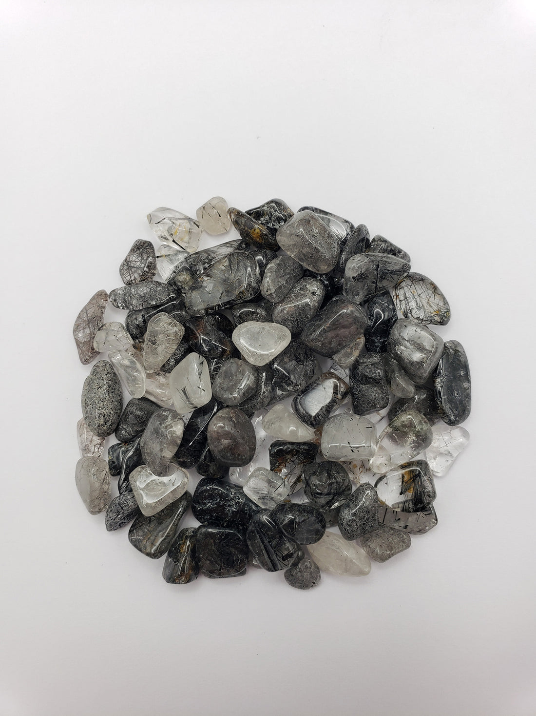 1 ounce of black tourmaline rutilated quartz on white background