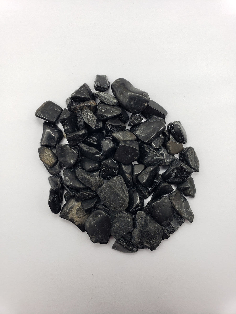 one ounce of black tourmaline crystal chips on white background