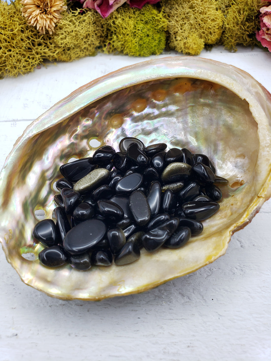 One ounce of gold sheen obsidian chips in an abalone shell