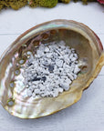 One ounce of howlite crystal chips in abalone shell