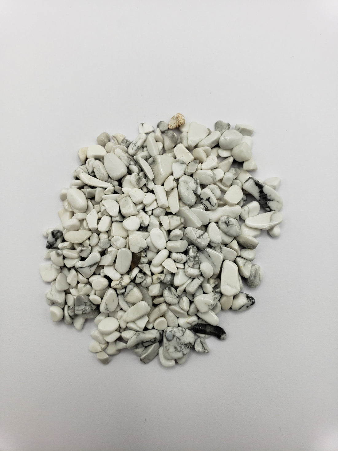 One ounce of howlite crystal chips on white background