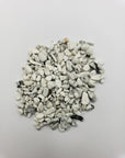 One ounce of howlite crystal chips on white background