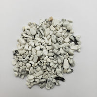 One ounce of howlite crystal chips on white background