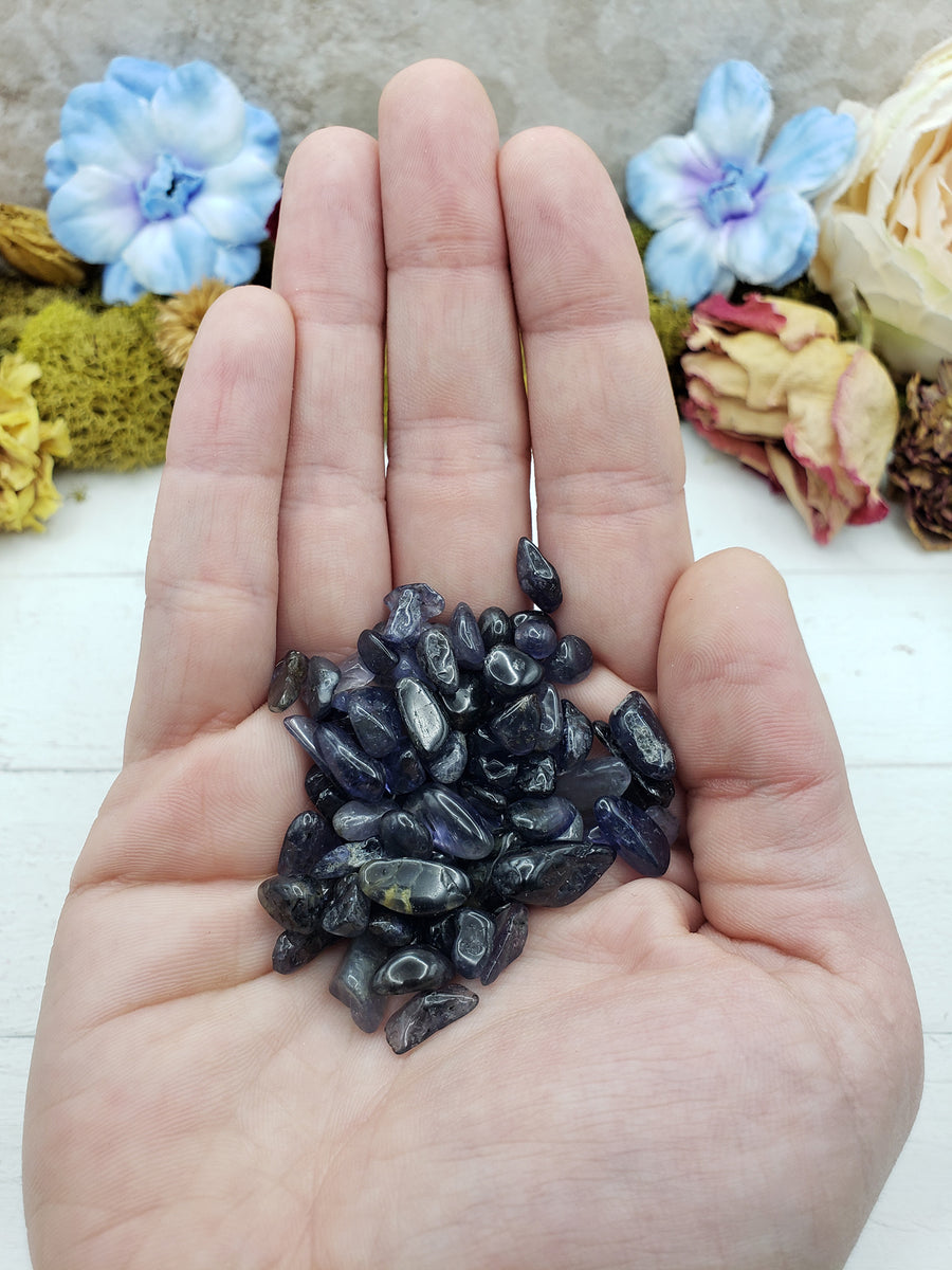 Hand holding one ounce of iolite crystal chips