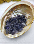 One ounce of iolite crystal chips in abalone shell