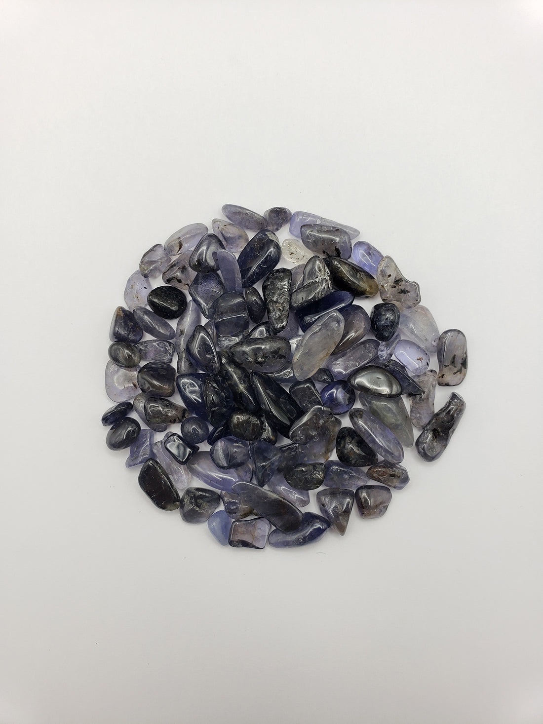 One ounce of iolite crystal chips on white background