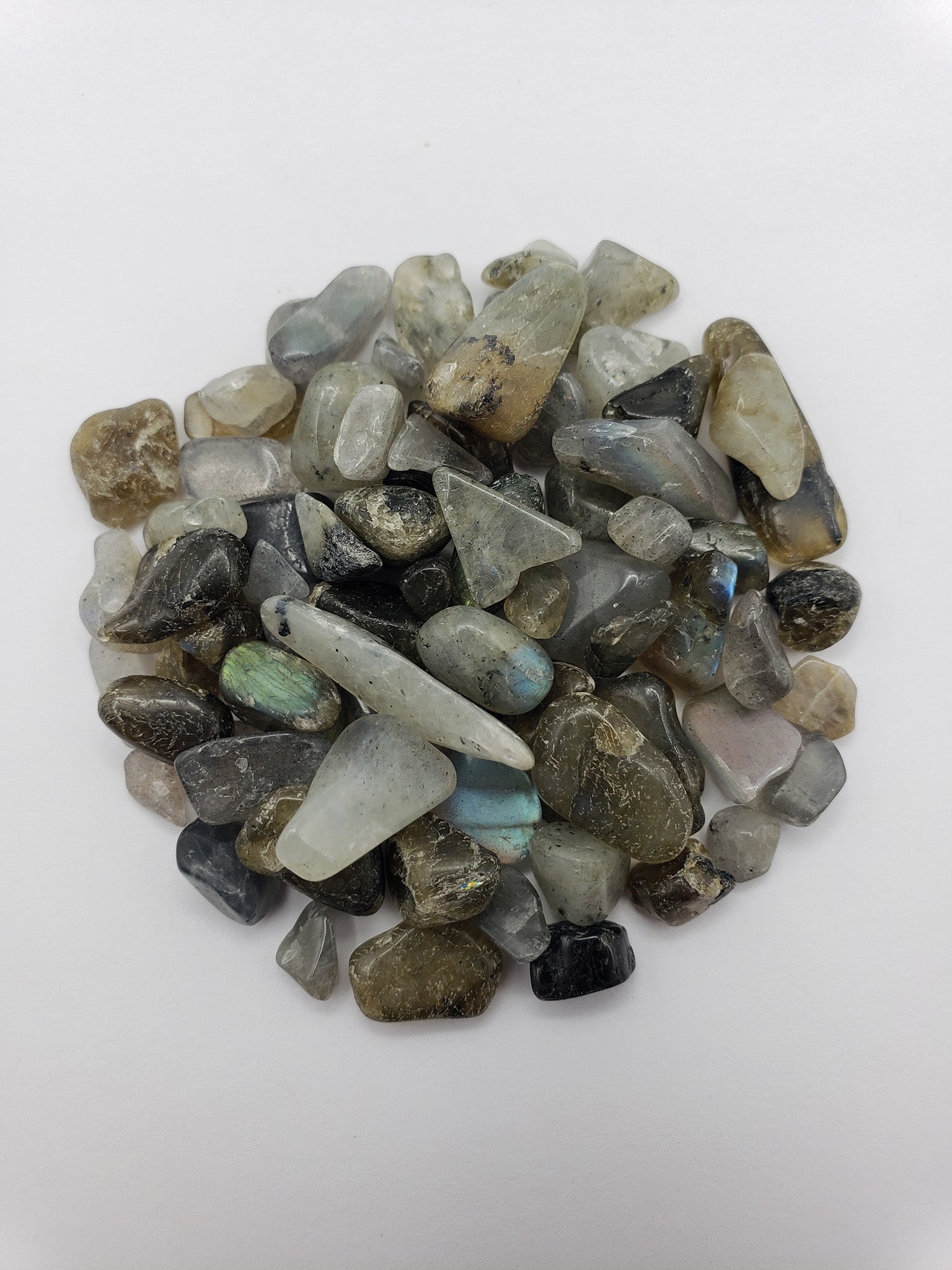 One ounce of labradorite crystal chips on white background