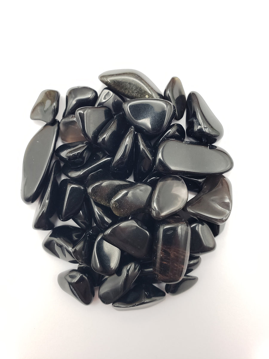 One ounce of Obsidian crystal chips on white background
