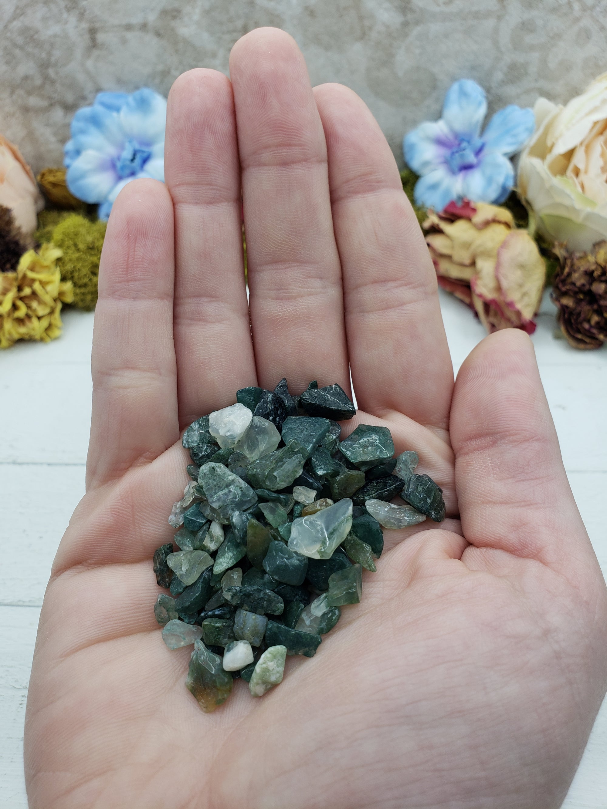 One ounce of green moss agate chips held in hand