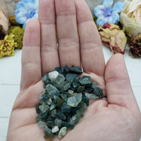 One ounce of green moss agate chips held in hand