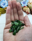 Hand holding one ounce of nephrite jade chips