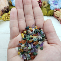 Hand holding one ounce of mixed gemstone crystal chips