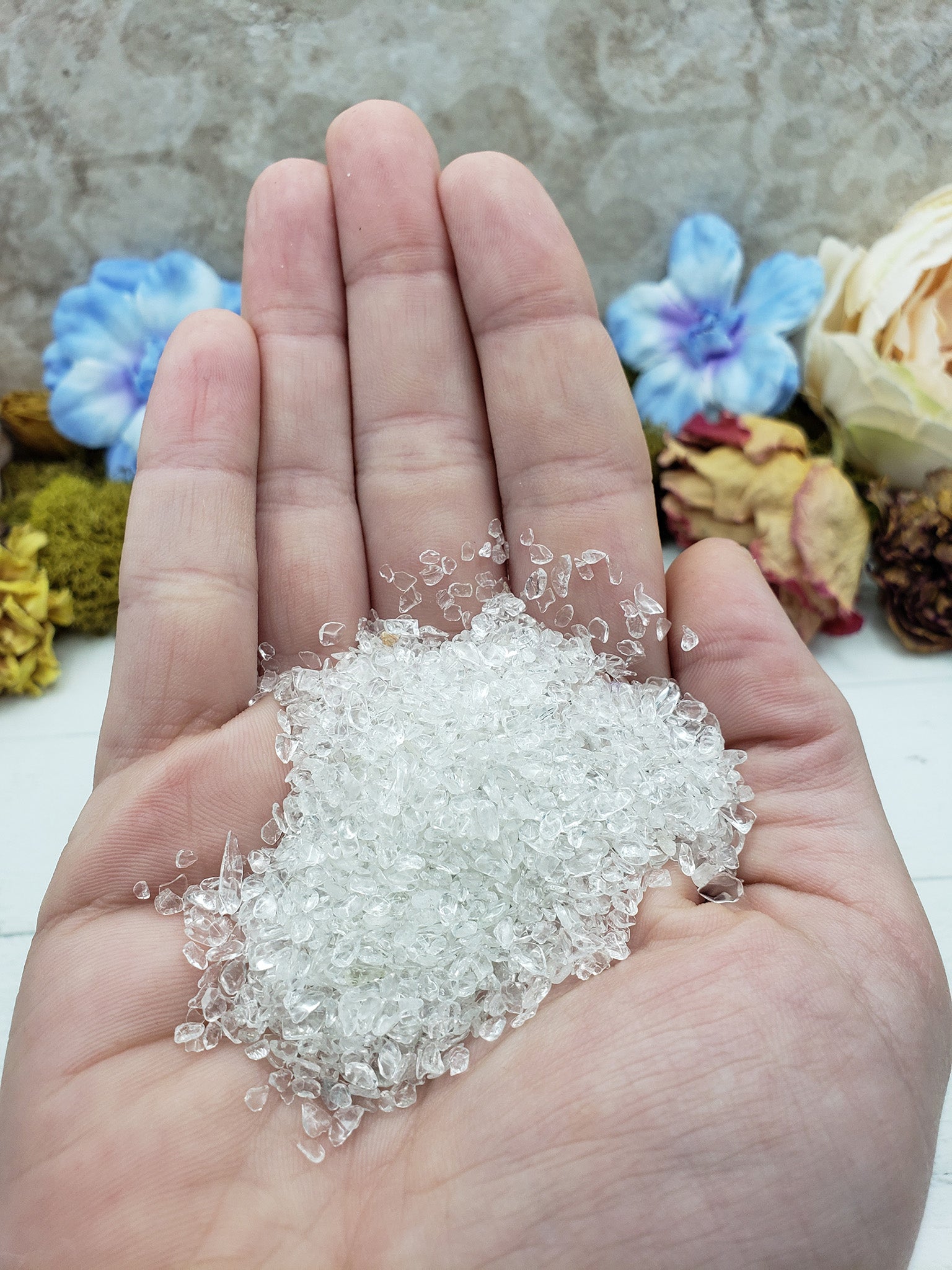 one ounce of quartz crystal chips in hand