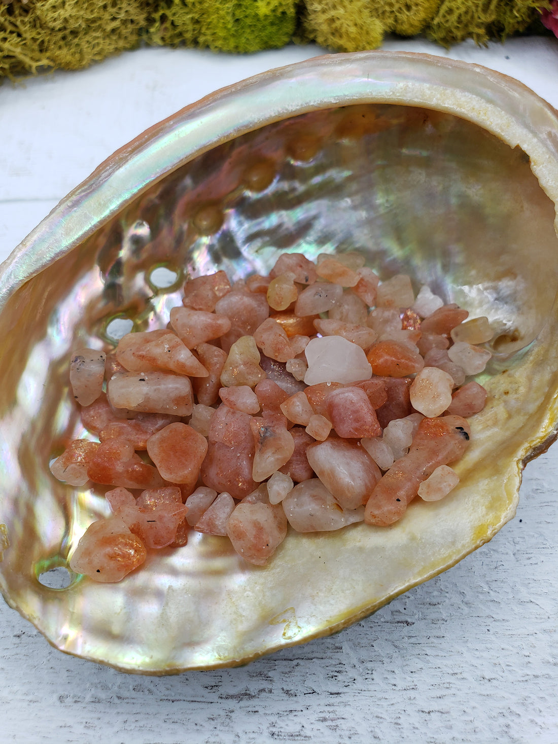 one ounce of sunstone crystal chips in abalone shell