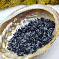 one ounce of snowflake obsidian chips in abalone shell