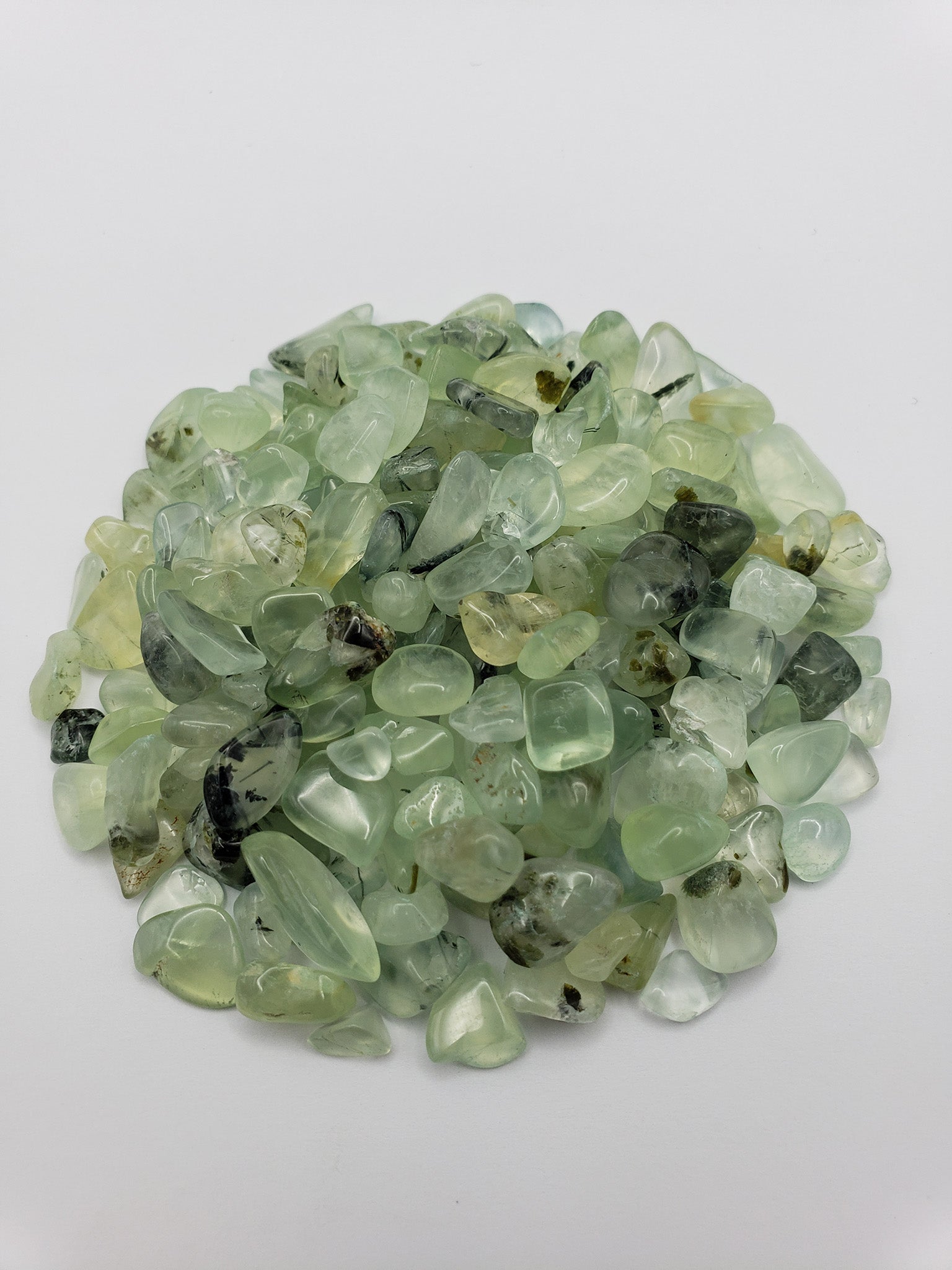 One ounce of prehnite chips on white background