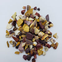 One ounce of mookaite crystal chips on white background